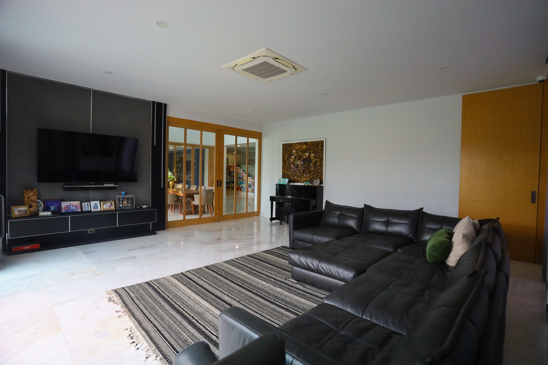 Family room with marble floors, opening through to the dining area